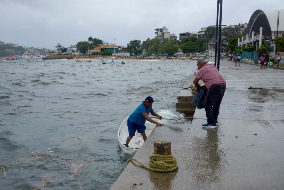 A man moors his boat in Acapulco, Guerrero State, Mexico, on August 16, 2023, following the passage of Tropical Storm Hilary.