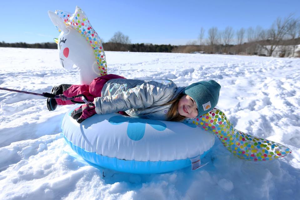 Lee resident Riley Perkins enjoys a day of sledding at Wagon Hill Farm in Durham Sunday, Jan. 30, 2022, following a blizzard the previous day.