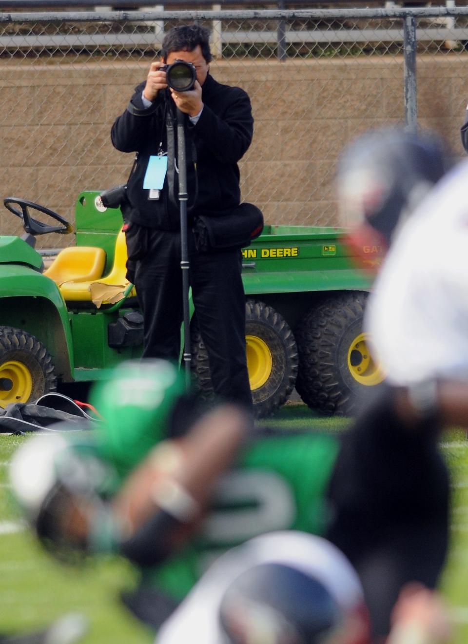 Record photographer Clifford Oto photographs the championship football game between St. Mary's High and Pleasant Grove High from Elk Grove on Dec. 13, 2008.