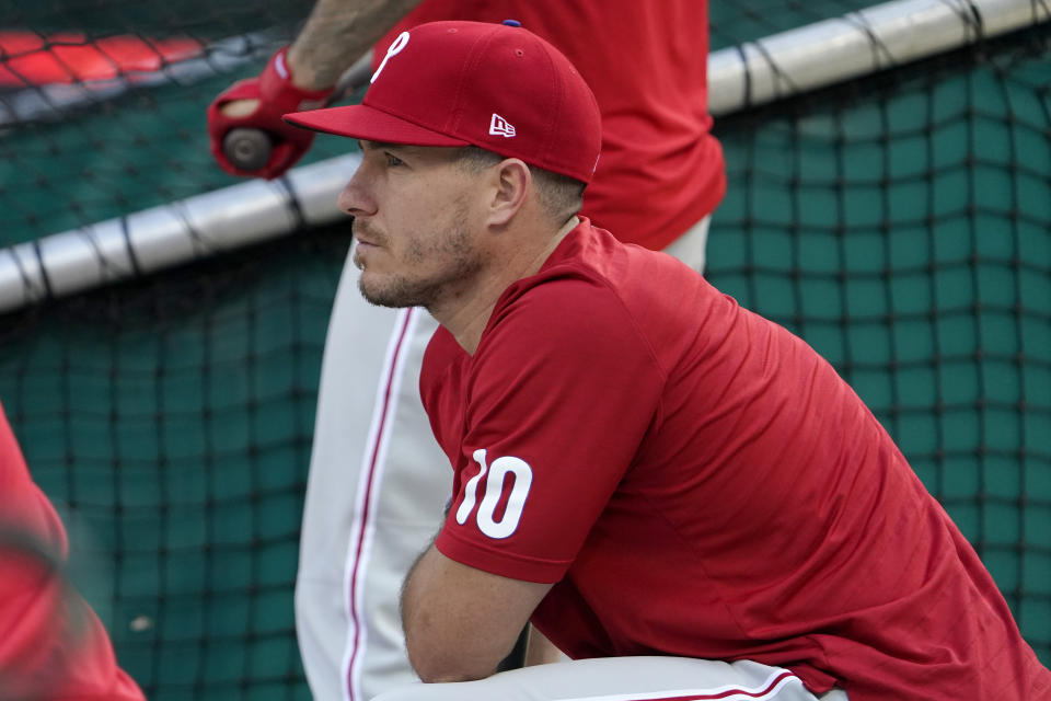 Philadelphia Phillies' J.T. Realmuto kneels during baseball practice Thursday, Oct. 6, 2022, in St. Louis. The Phillies and St. Louis Cardinals are set to play Game 1 of a National League Wild Card baseball playoff series on Friday in St. Louis. (AP Photo/Jeff Roberson)