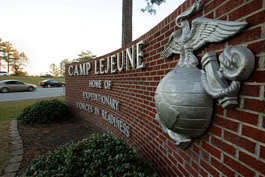 Cars enter the main gate Friday at Camp Lejeune in Jacksonville, N.C. Ten Marines with the Regimental Combat Team 8, 2nd Marine Division, from Camp Lejeune were killed Thursday by a roadside bomb outside Fallujah, Iraq. Gerry Broome | Associated Press