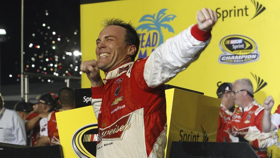 FILE - Kevin Harvick celebrates after winning the NASCAR Sprint Cup championship series auto race, Sunday, Nov. 16, 2014, in Homestead, Fla. Kevin Harvick said Thursday, Jan. 12, 2023, he will retire from NASCAR competition at the end of the 2023 season. (AP Photo/Terry Renna, File)