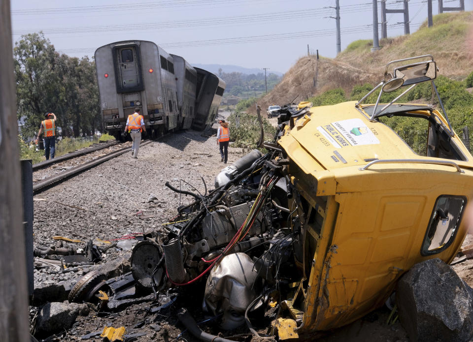 A destroyed truck lies next to a derailed Amtrak train in Moorpark, Calif., on Wednesday, June 28, 2023. Authorities say an Amtrak passenger train carrying 190 passengers derailed after striking a vehicle on tracks in Southern California. Only minor injuries were reported. (Dean Musgrove/The Orange County Register via AP)