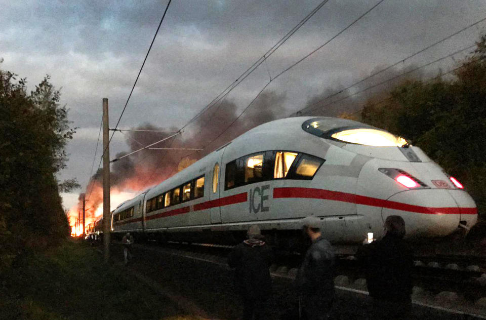Flames and smoke rise over an ICE train near Montabaur, western Germany, Friday morning, Oct. 12, 2018. Nobody was injured when the high-speed train was evacuated after it caught fire for unknown reasons. (Ute Lange/dpa via AP)