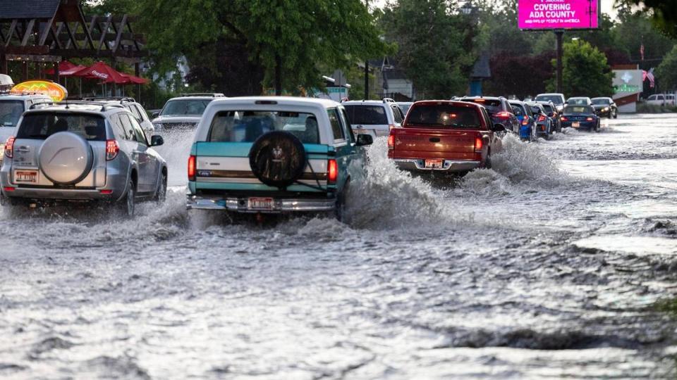 Traffic on State Street in Boise negotiates the floodwater from 15th Street to beyond 18th Street after a chain of thunderstorms drenched Boise.
