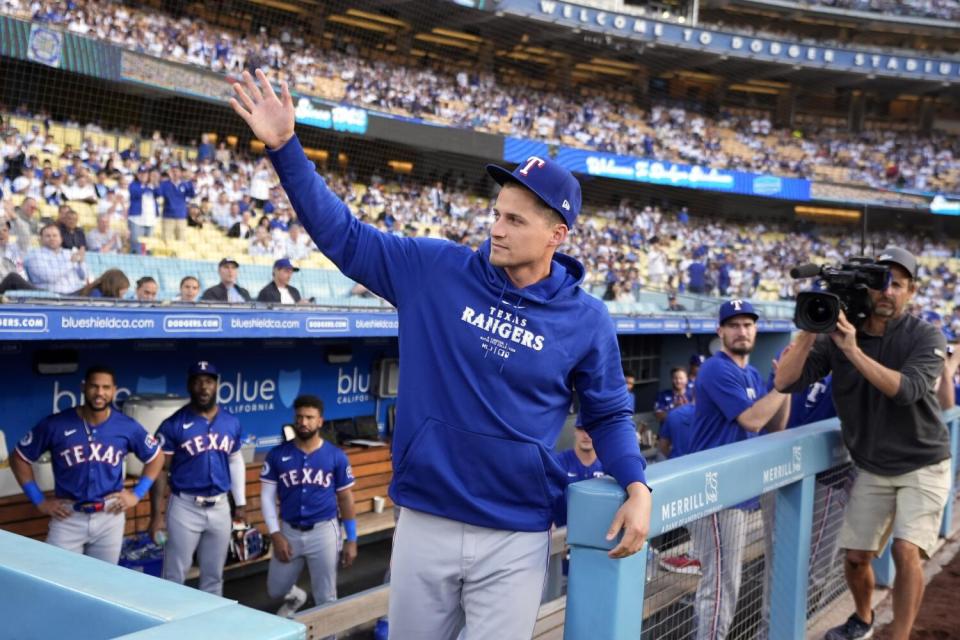 Rangers' Corey Seager waves to fans after being recognized by the announcer at Dodger Stadium