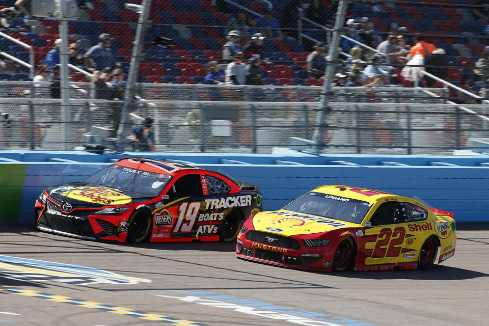 Martin Truex Jr (19) and Joey Logano (22) race through Turn 4 during a NASCAR Cup Series auto race at Phoenix Raceway, Sunday, March 14, 2021, in Avondale, Ariz. (AP Photo/Ralph Freso)