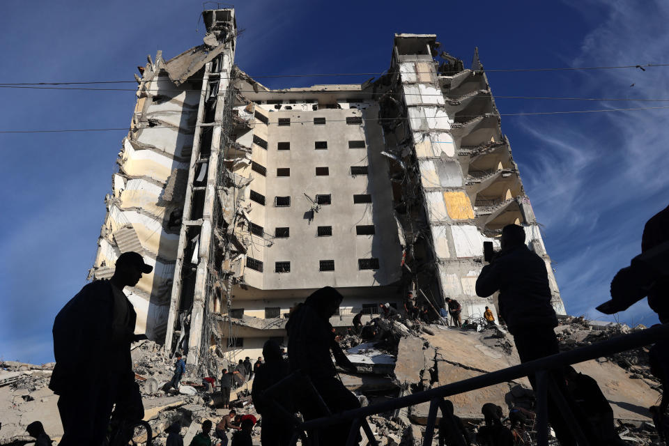 TOPSHOT - Palestinians gather in front of a residential building hit in an overnight Israeli air strike in Rafah in the southern Gaza Strip on March 9, 2023, amid continuing battles between Israel and the Palestinian militant group Hamas. (Photo by SAID KHATIB / AFP) (Photo by SAID KHATIB/AFP via Getty Images)