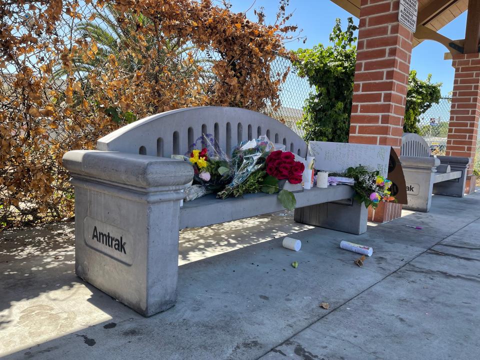 Flowers were set out on a bench at the Oxnard Transportation Center after two people were shot to death in June.