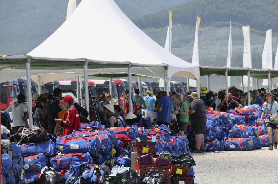 British scout members gather to leave the World Scout Jamboree campsite in Buan, South Korea, Saturday, Aug. 5, 2023. The world scouting body urged South Korea to cut short the World Scout Jamboree as thousands of British scouts began leaving the coastal campsite Saturday because of a punishing heat wave and American scouts talked of pulling out. (Kim Joo-hyung/Yonhap via AP)