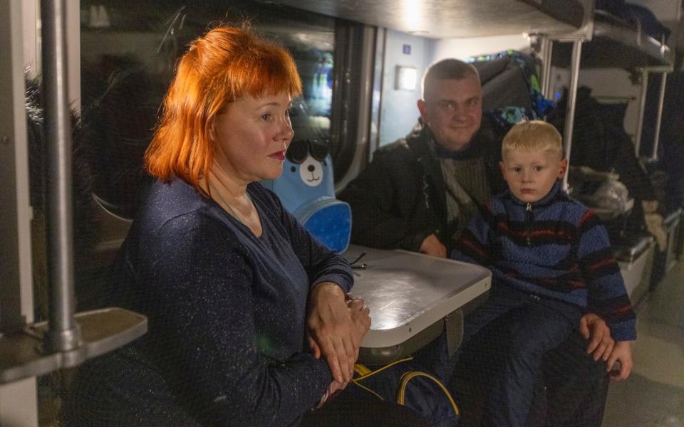 Diana her son Igor ( 4 yrs old first time on train) and husband Vitaly waiting for the evacuation train to leave for Kyiv - Heathcliff O'Malley for The Telegraph