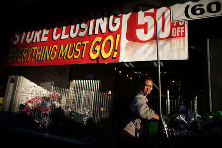 A woman works in a store that has a sign indicating it is going out of business, in Nogales, Arizona, U.S., January 31, 2017. REUTERS/Lucy Nicholson