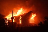 <p>The Signorello Estate Winery burns in the Napa wine region in Calif., on Oct. 9, 2017, as multiple wind-driven fires continue to whip through the region. (Photo: Josh EdelsonAFP/Getty Images) </p>