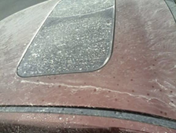 Milky rain gave this red car a white sheen in the inland Northwest of the United States.