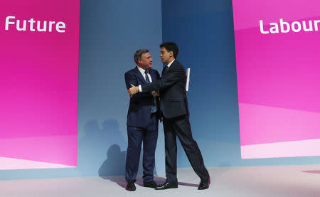 Britain's shadow chancellor Ed Balls (L) shakes hands with Britain's opposition Labour Party leader Ed Miliband after his speech during the Labour party's annual conference in Manchester, northern England September 22, 2014. REUTERS/Suzanne Plunkett