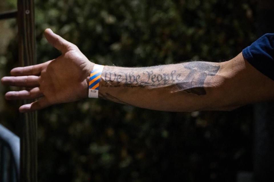 Neimiah DeLozier, of Marysville, shows one of his tattoos while waiting to see Jason Aldean perform at his Highway Desperado tour concert Thursday, Sept. 21, 2023, at Toyota Amphitheatre in Yuba County.