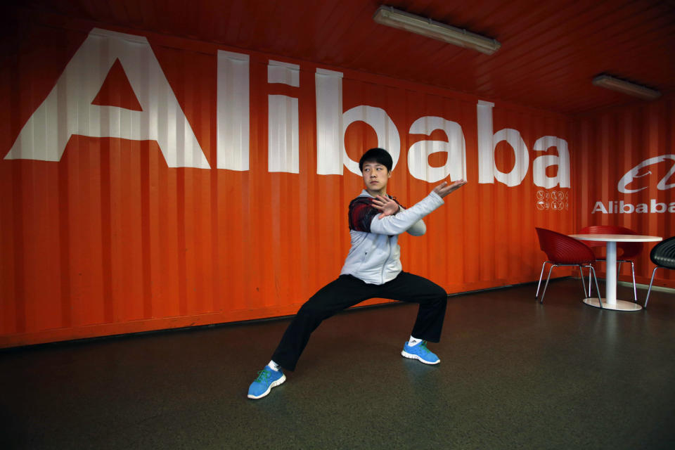 FILE - In this file photo taken Tuesday March 26, 2013, a worker performs shadow boxing during an open day at the e-commerce giant Alibaba Group office in Hangzhou in east China's Zhejiang province. As Alibaba gets ready for its blockbuster U.S. stock sale in the next few months, technology companies are getting slammed in the market. (AP Photo/File) CHINA OUT