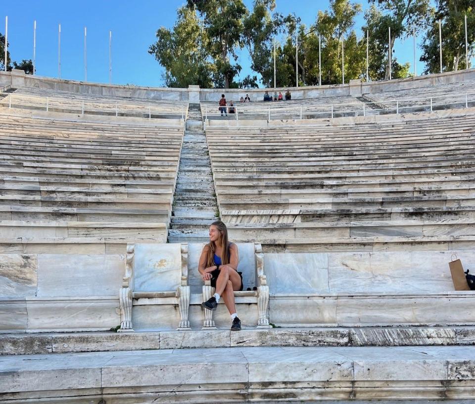 Former Harlem standout McKaela Schmelzer, who now plays professional soccer and is based just outside of Athens, Greece, looks out over the Panathenaic Stadium during a recent visit to the famous city of Athens.