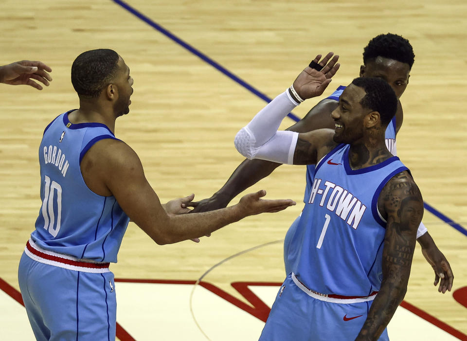 Houston Rockets guard Eric Gordon (10) and guard John Wall (1) celebrate after a play during the fourth quarter of an NBA basketball game against the Portland Trail Blazers, Thursday, Jan. 28, 2021, in Houston. (Troy Taormina/Pool Photo via AP)