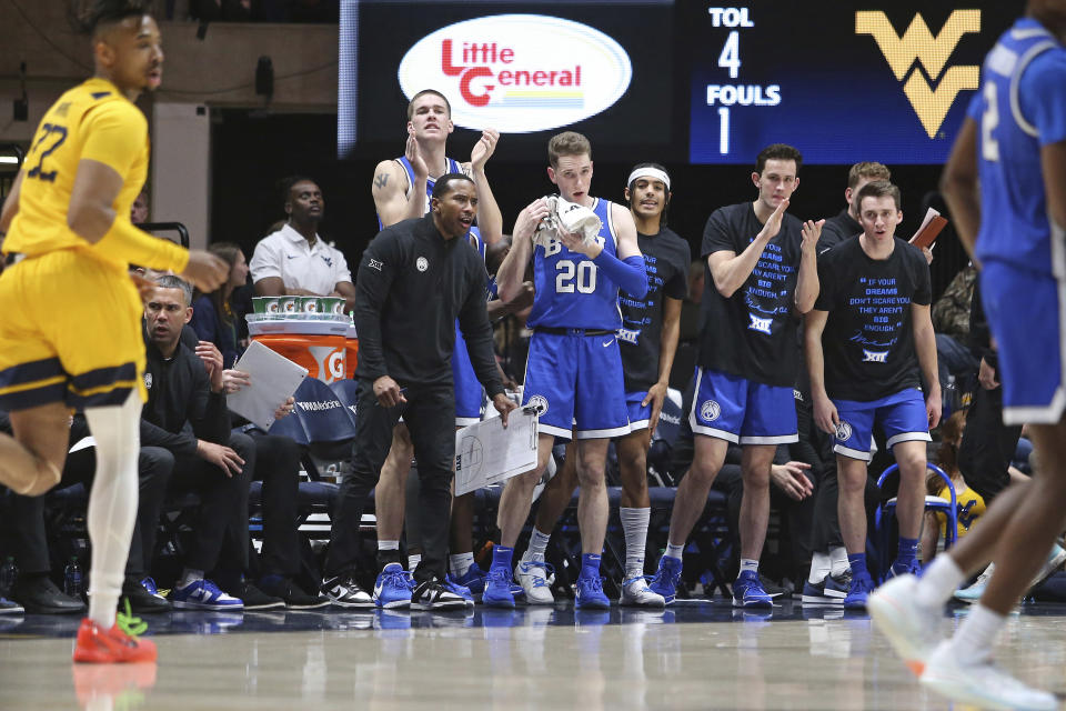 BYU players react from the bench during the first half of an NCAA college basketball game against West Virginia, Saturday, Feb. 3, 2024, in Morgantown, W.Va. (AP Photo/Kathleen Batten)