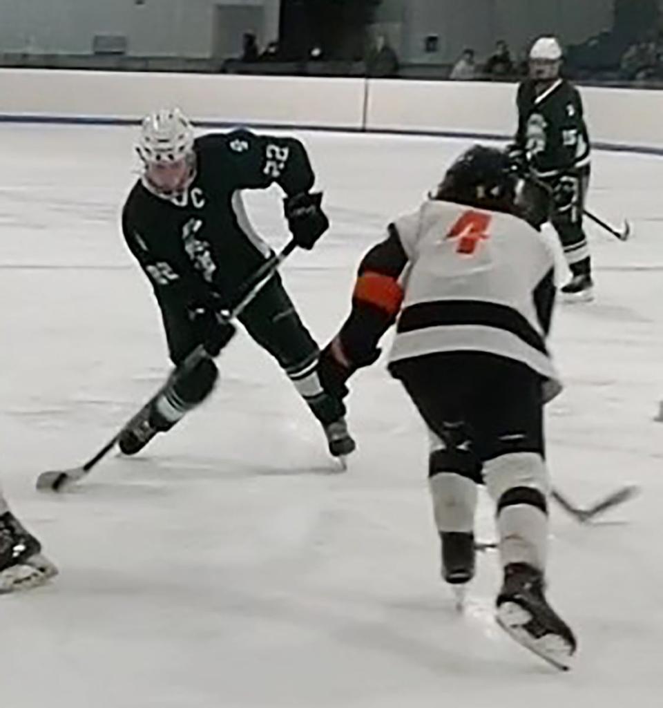 Oakmont's Blake Riggins takes a shot on goal as Gardner's Ty Burdett steps up to try and block the puck.