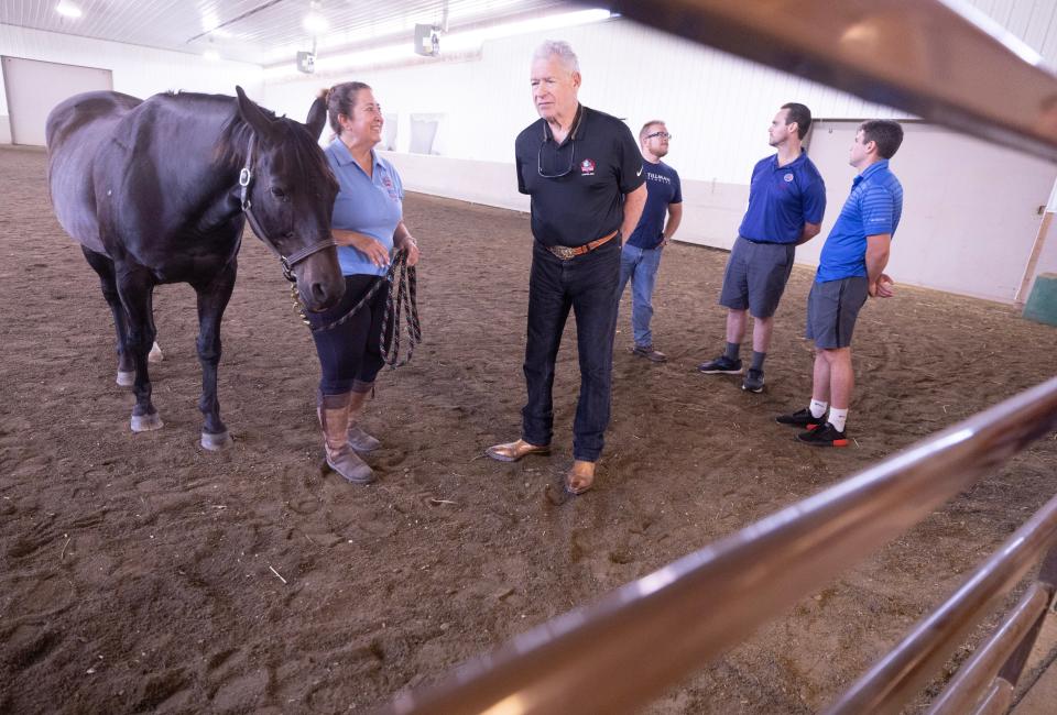 Pro Football Hall of Famer John Riggins talks to Missy Howard, center coordinator at the Pegasus Farm-operated Military and First Responders Center near Louisville.