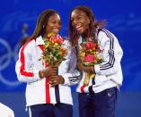 <p>Venus and Serena Williams of the USA celebrate gold after winning the Womens Doubles Tennis Final at the NSW Tennis Centre on Day 13 of the Sydney 2000 Olympic Games in Sydney, Australia. Mandatory Credit: Gary M Prior/Allsport </p>