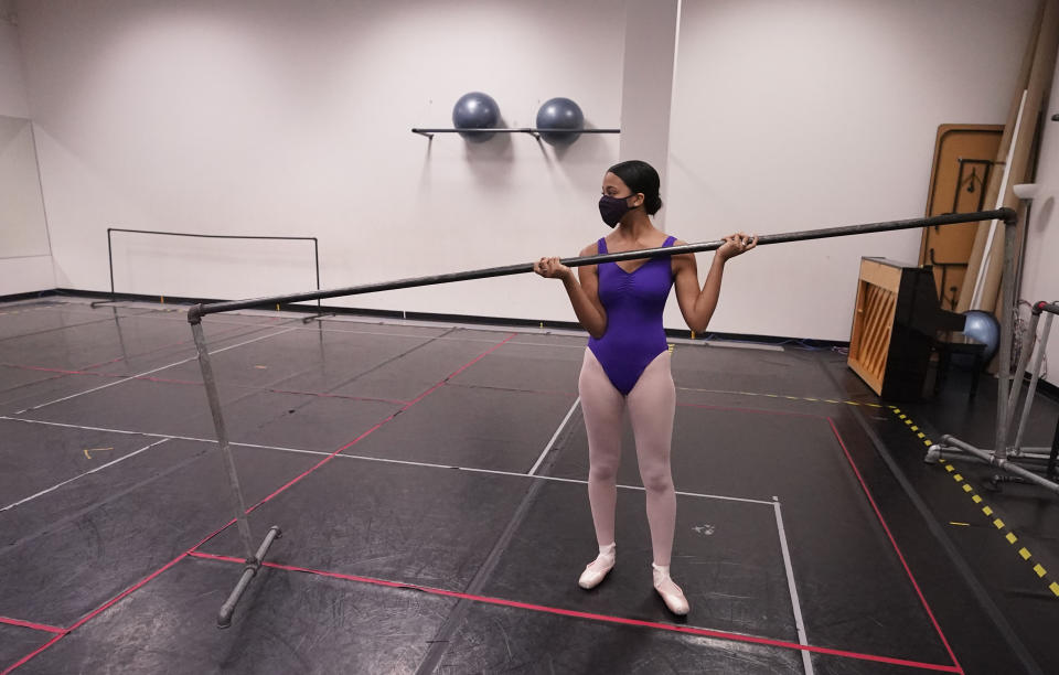 Ballet student Micah Sparrow moves a bar into place to stretch in a classroom at the Texas Ballet Theatre, Wednesday, Oct. 7, 2020, in Fort Worth, Texas. For many, it's not Christmas without the dance of Clara, Uncle Drosselmeyer, the Sugar Plum Fairy, the Mouse King and, of course, the Nutcracker Prince. But this year the coronavirus pandemic has canceled performances of “The Nutcracker” around the U.S. and Canada, eliminating a major and reliable source of revenue for dance companies already reeling financially following the essential shutdown of their industry. (AP Photo/LM Otero)