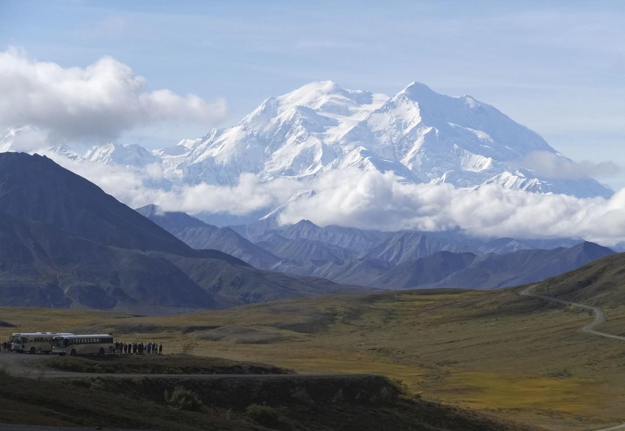 In this Aug. 26, 2016, file photo sightseeing buses and tourists are seen at a pullout popular for taking in views of North America's tallest peak, Denali, in Denali National Park and Preserve, Alaska. A climber was killed and another was significantly injured when they were hit by a falling block of glacier ice in Alaska's Denali National Park and Preserve, an official said Friday, May 14, 2021. The two were hit by the hanging serac after it dislodged from a peak off the West Fork of the Ruth Glacier.