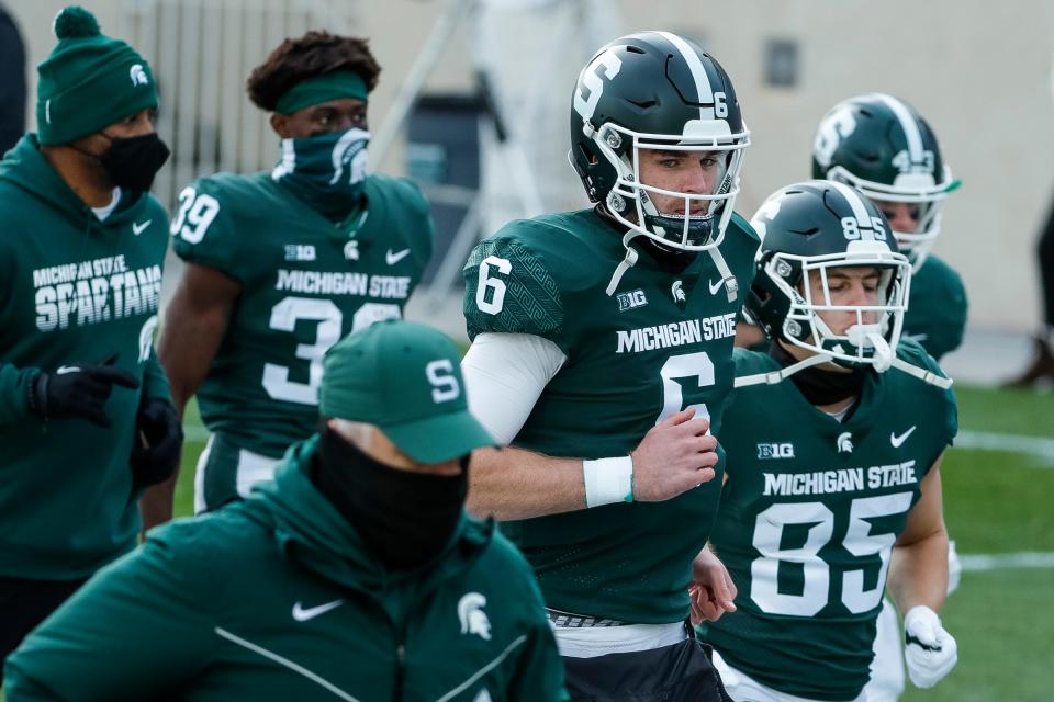 Michigan State quarterback Theo Day runs off the field after MSU's 24-0 loss to Indiana at Spartan Stadium on Saturday, Nov. 14, 2020.