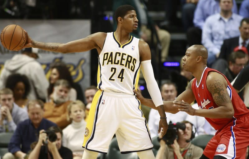 Indiana Pacers' George holds the basketball away from Los Angeles Clippers' Butler during the first half of their NBA basketball game in Indianapolis, Indiana