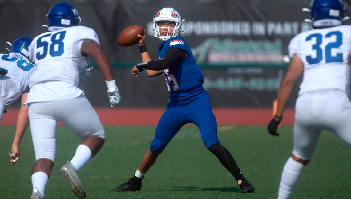 Graham-Kapowsin quarterback Daveon Superales looks to pass downfield under pressure from Curtis defenders (from left) Marquis Watson, Bryce Bouyer and Memphis Robinson during Saturday’s football game at Art Crate Field in Spanaway, Washington, Oct. 8, 2022. Graham-Kapowsin won the game, 24-19.