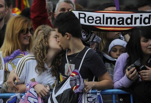 Real Madrid's supporters are seen celebrating at Cibeles square in Madrid, on May 3, a day after Real Mdrid won the Spanish league title for the first time since 2008. Real Madrid's 3-0 away win over Athletic Bilbao sealed the league, putting them seven points clear of last year's winners and arch rivals Barcelona with just two games to go and delivering the team's 32nd league crown