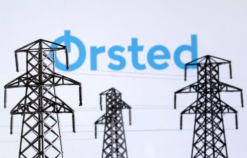FILE PHOTO: Illustration shows Electric power transmission pylon miniatures and Orsted logo