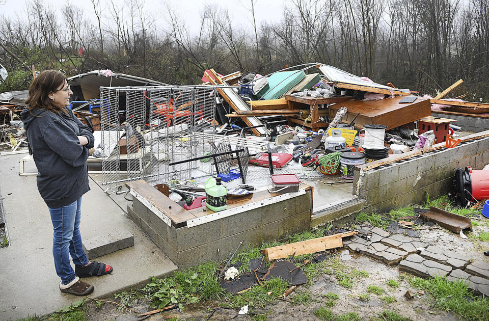 Kay Persinger looks out over what was once her daughter's garage on Lookout Road in Hico, W.Va., Wednesday, April 3, 2024. Persinger was tucked down in the corner of the garage when a storm hit the area the day before. Persinger survived the storm but suffered a gash on her left leg and fractured two toes. (Rick Barbero/The Register-Herald via AP)