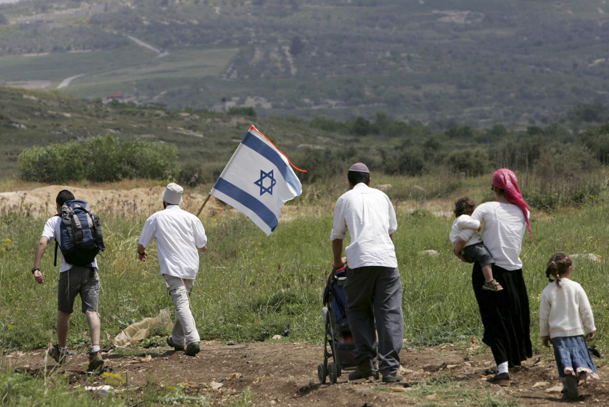 Israeli activists walk towards Homesh, in the northern West Bank.