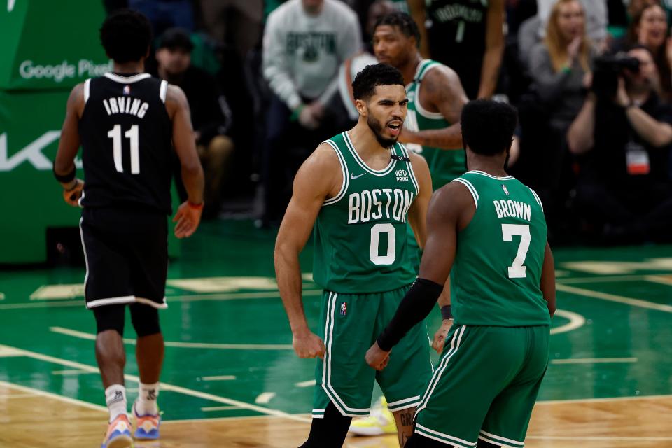 Jayson Tatum (0) celebrates a big fourth-quarter bucket with guard Jaylen Brown (7).