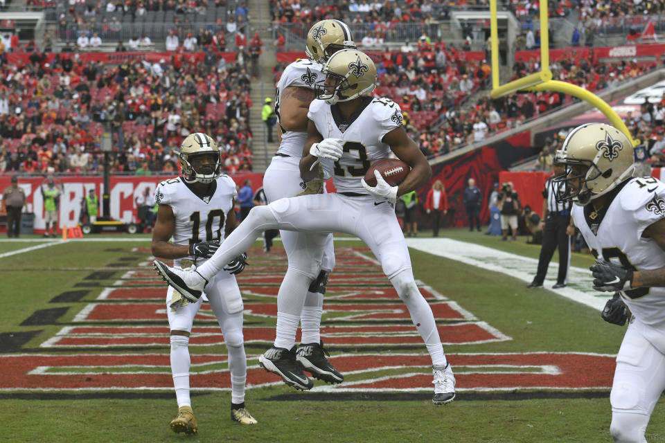 New Orleans Saints wide receiver Michael Thomas (13) celebrates his 16-yard touchdown reception with wide receiver Tre'Quan Smith (10) and center Erik McCoy (78) during the first half of an NFL football game Sunday, Nov. 17, 2019, in Tampa, Fla. (AP Photo/Jason Behnken)