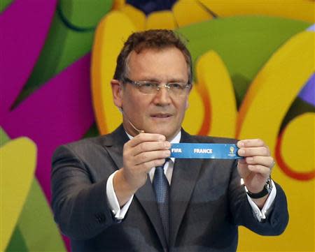 FIFA Secretary General Jerome Valcke holds the slip showing "France" during the draw for the 2014 World Cup at the Costa do Sauipe resort in Sao Joao da Mata, Bahia state, December 6, 2013. REUTERS/Sergio Moraes