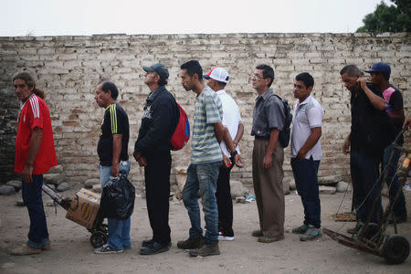 Venezuelans line up as they wait for a free breakfast at the "Divina Providencia" migrant shelter on the outskirts of Cucuta, on the Colombian-Venezuelan border, Colombia February 14, 2019. REUTERS/Edgard Garrido