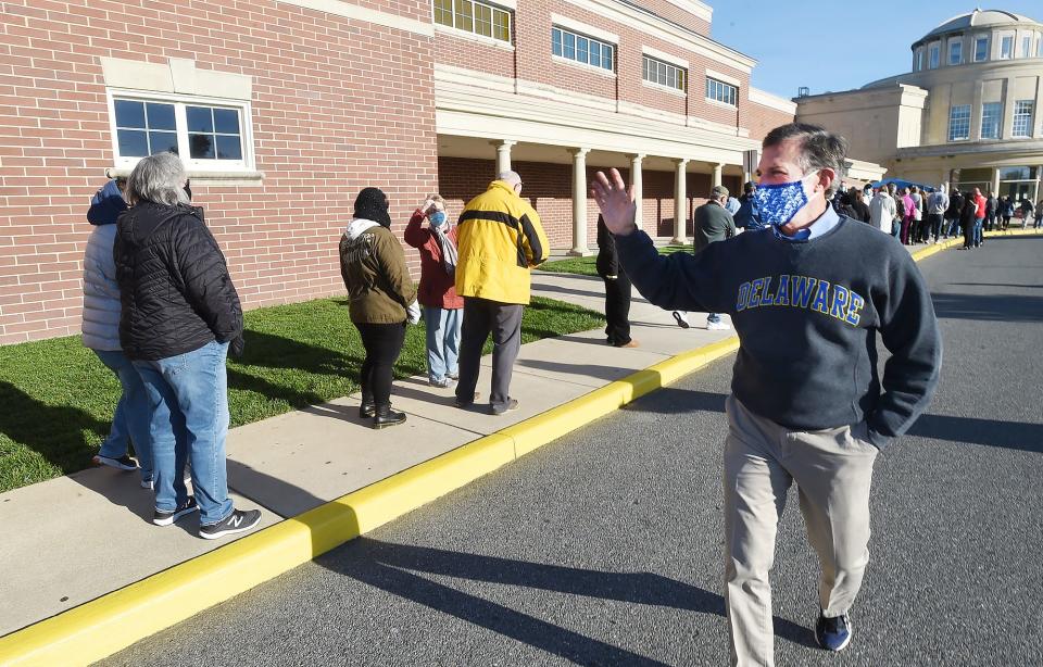 Voters wait in line to vote on a cold blustery morning Tuesday at Cape Henlopen High School in Lewes.