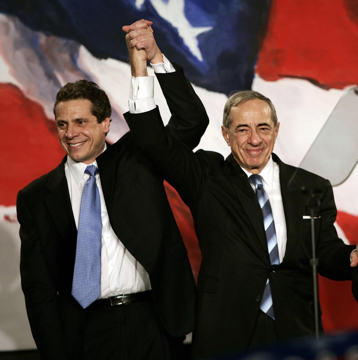 New York Attorney General Elect Andrew Cuomo, left, joins hands with his father former New York Governor Mario Cuomo during a rally held by New York Democrats, in New York, on Nov. 7, 2006.