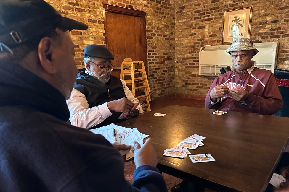 Tyrone Dash, pictured left, plays cards with longtime friends in Orangeburg County at Dash's restaurant.