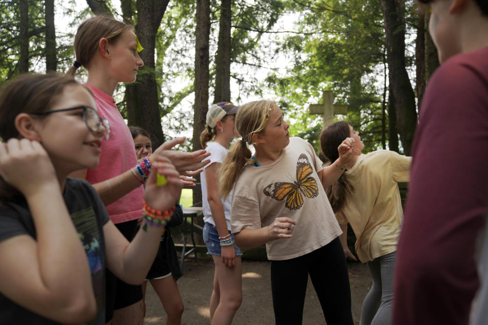 Campers play a game of charades under a canopy of trees at the YMCA Camp Kon-O-Kwee Spencer on Thursday, June 29, 2023, in Zelienople, Pa. Due to the poor air quality caused by the Canadian wildfires the Western Pennsylvania summer camp closed its outdoor pool and sent home a few campers with health problems. (AP Photo/Jessie Wardarski)