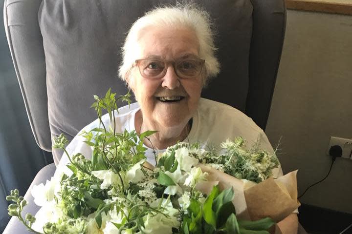 A patient receives a bouquet of flowers made from Prince Harry and Meghan's wedding: St Joseph's Hospice, Hackney