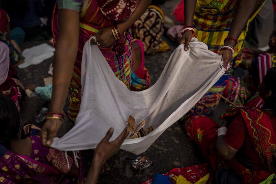 Tribes women collect donations during a sit-in demonstration rally to demand of recognizing Sarna Dharma as a religion in Ranchi, capital of the eastern Indian state of Jharkhand, Oct. 18, 2022. Tribal groups have held protests in support of giving Sarna Dharma official religion status in the run-up to the upcoming national census, which has citizens state their religious affiliation. (AP Photo/Altaf Qadri)