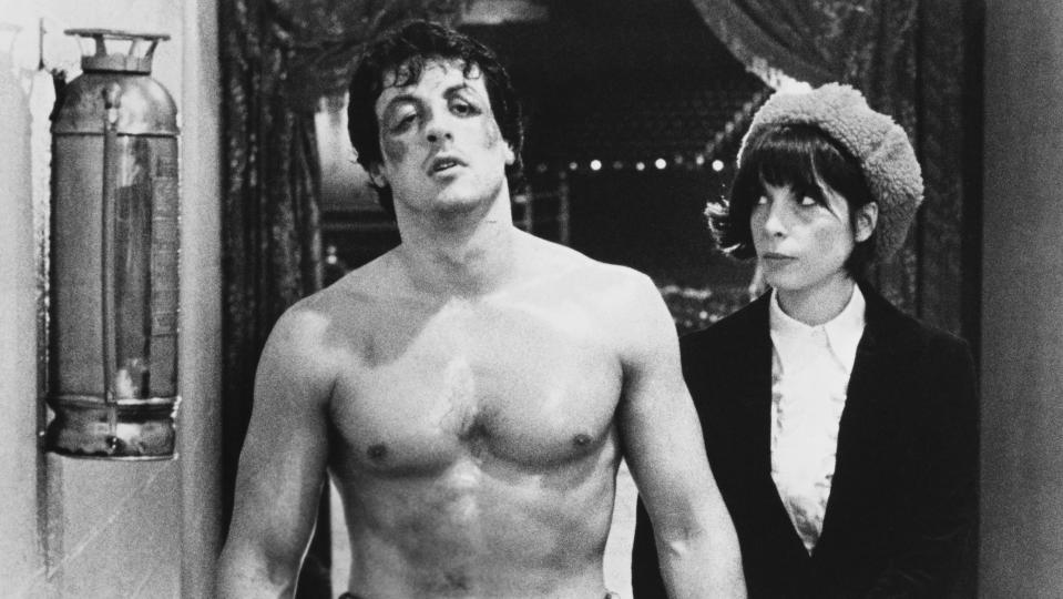 <span><span>Sylvester Stallone as Rocky Balboa and Talia Shire as Adrian in <em>Rocky,</em> 1976</span></span>