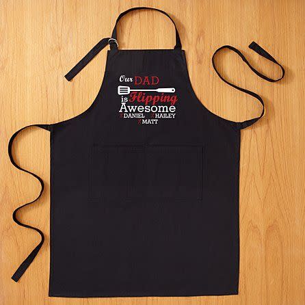 <p><strong>Personal Creations</strong></p><p>personalcreations.com</p><p><strong>$22.49</strong></p><p><a href="https://www.personalcreations.com/product/flipping-awesome-grilling-apron-30201813" rel="nofollow noopener" target="_blank" data-ylk="slk:Shop Now;elm:context_link;itc:0;sec:content-canvas" class="link ">Shop Now</a></p><p>He's flipping awesome at life and more specifically, flipping burgers. You can choose between a "My Dad" or "Our Dad" option if you have siblings, and get your names all stitched into this personalized apron.</p>