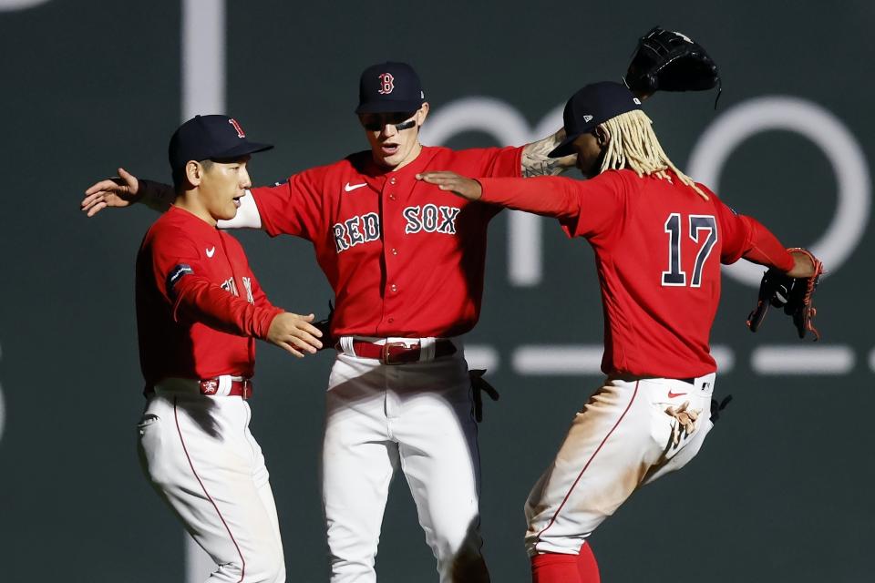 Boston Red Sox outfielders, from left to right, Masataka Yoshida, Jarren Duran and Raimel Tapia celebrate after defeating the Toronto Blue Jays in a baseball game, Thursday, May 4, 2023, in Boston. (AP Photo/Michael Dwyer)
