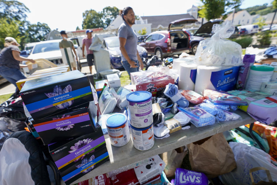 Volunteers with a Seventh Day Adventist church sort donated items to be distributed people in need after remnants of Hurricane Ida inundated the community, Saturday, Sept. 4, 2021, in Mamaroneck, N.Y. More than four days after the hurricane blew ashore in Louisiana, Ida's rainy remains hit the Northeast with stunning fury on Wednesday and Thursday, submerging cars, swamping subway stations and basement apartments and drowning scores of people in five states. (AP Photo/Mary Altaffer)